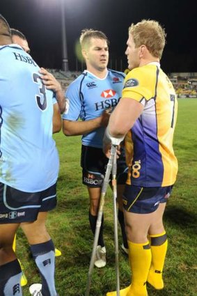 Drew Mitchell  and an injured David Pocock chat after the Waratahs Brumbies clash on Saturday.