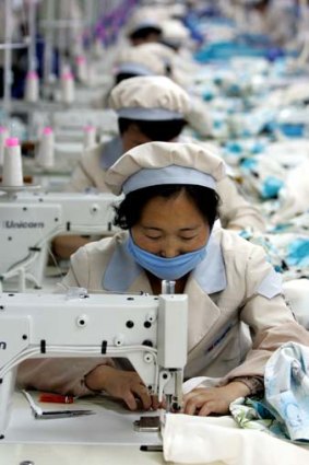 Comfortable with the commute: Apparel workers work at a factory in Kaesong, just a few hundred metres north of the heavily fortified demilitarised zone that divides the Korean peninsula.
