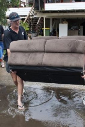 People remove belongings from homes ahead of a predicted flood in Enid Street in Ipswich in 2011.