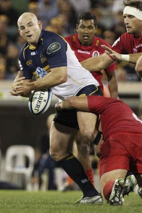 Stephen Moore of the Brumbies fumbles the ball in a tackle.