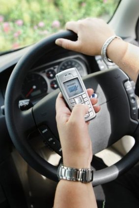 Risky practice: Using mobile phones while behind the wheel is dangerous.