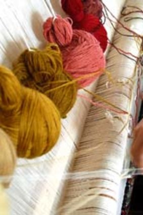 Women weave carpets in Quba.