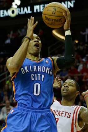 Russell Westbrook of the Oklahoma City Thunder goes up for a shot over Marcus Morris of the Houston Rockets.