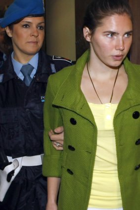Amanda Knox is accompanied by a prison officer prior to a final hearing before the verdict, at the court in Perugia, Italy.
