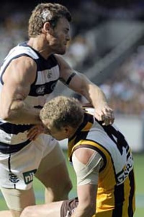 Hawthorn's Rick Ladson hit by Geelong's Cameron Mooney.