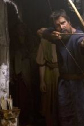 Straight and true: Moses (Christian Bale) takes aim, as Nun (Ben Kingsley) looks on. 