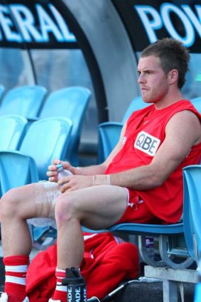 Devastated ... Ben McGlynn sits injured on the bench during the Qualifying Final match against the Adelaide Crows.