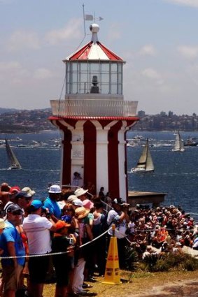 Crowds watch the Sydney to Hobart yacht race from South Head.