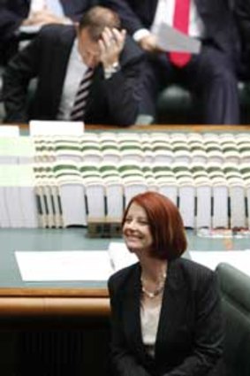 Winners are grinners ... Tony Abbott and Julia Gillard during question time in Parliament.
