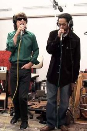 Stone in the studio with Mick Jagger (left) and Damian Marley.