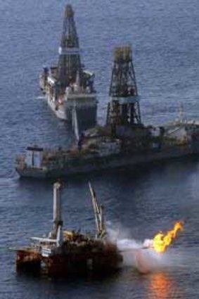A platform burns off excess gas near drill ships assisting in the capping of the Deepwater Horizon oil well.