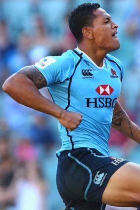 Jubilation: Israel Folau of the Waratahs celebrates after scoring a try against the Blues.