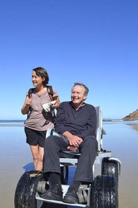 David and Ros Stratton with a four-wheel-drive beach access chair.