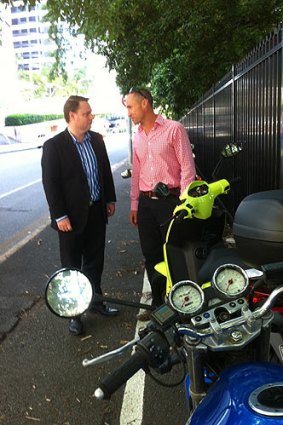 Paul Peterson from the motorcycle division of the MTAQ talks to Deputy Mayor Adrian Schrinner about extra motorcycle and scooter spaces.
