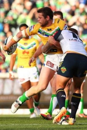 Shaun Fensom off loads before Tariq Sims dumps him on his neck during the round 11 NRL match between the Canberra Raiders and the North Queensland Cowboys.