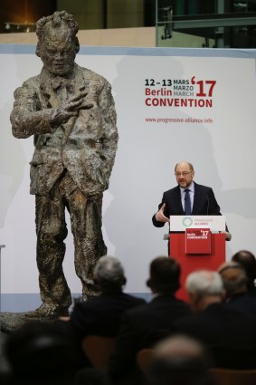 Top candidate in the upcoming general elections, Martin Schulz, right, delivers his speech at convention. In background is a sculpture of late chancellor Willy Brandt. 