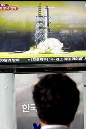 A man watches a TV news reporting about the missile launch by North Korea at a train station in Seoul, South Korea.