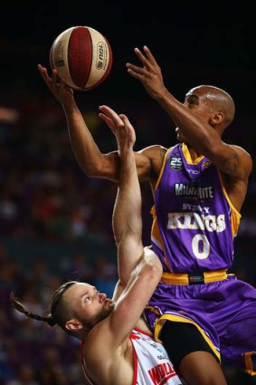 Kings combo guard Charles Carmouche drives to the basket against Hawks centre Larry Davidson during Sydney's loss to Wollongong at the Kingdome.