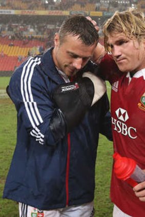 Another casualty: Tommy Bowe is consoled by Richard Hibbard after breaking his hand against the Reds. The injury rules the winger out of the tour.