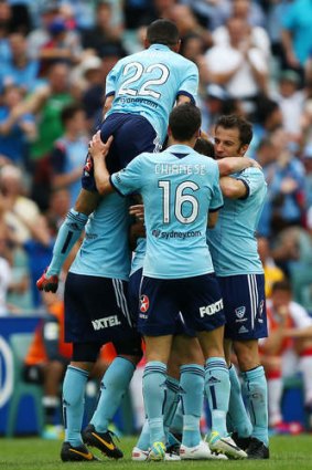 Sydney FC's Ranko Despotovic is swamped by team mates after scoring the Sky Blues' second goal.