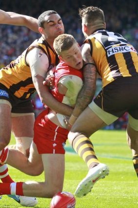 Crunch time: Swan Daniel Hannebery (top) is sandwiched by Hawthorn's Shaun Bourgoyne and Lace Franklin.
