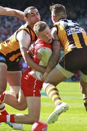 Crunch time: Swan Daniel Hannebery (top) is sandwiched by Hawthorn's Shaun Bourgoyne and Lace Franklin.