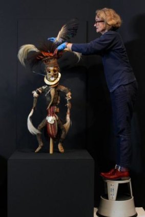An object from the Plumes and Pearlshells exhibition gets the loving treatment from AGNSW Objects Conservator Kerry Head.