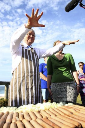 Hot to trot: Kevin Rudd gives a hand at a barbecue in the seat of Dobell on the central coast.