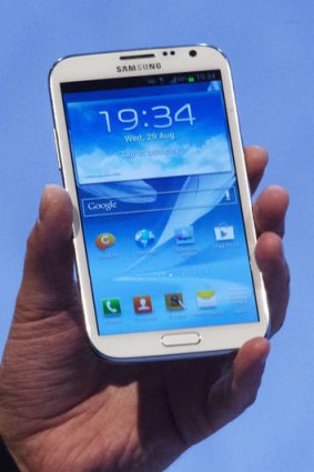 Jean-Daniel Ayme, vice president European Telecom Operations at Samsung, holds a new Galaxy Note II at the Samsung event in Berlin.