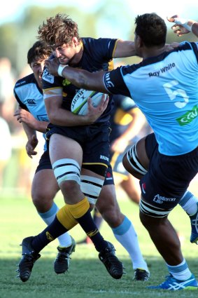 The Brumbies' Sam Carter fends off the Waratahs' Will Skelton.
