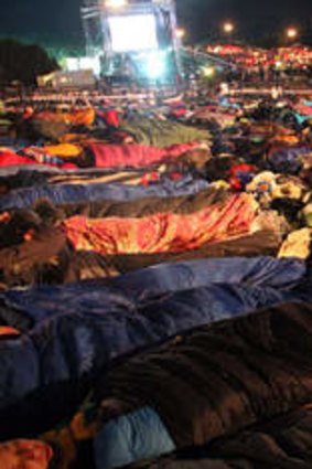Thousands sleep outside before a ceremony marking the 98th anniversary of Anzac Day at Anzac Cove, in western Canakkale.