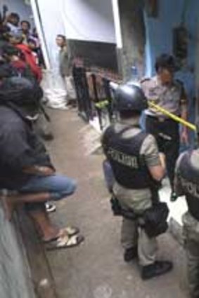 Troops surround the house of a suspected militant.