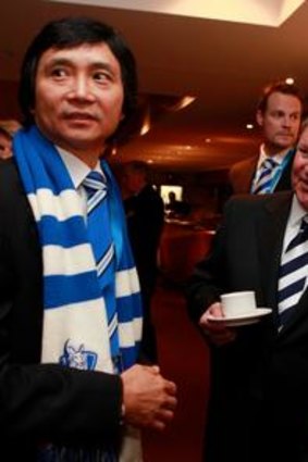 Mitchell with Li Cunxin and Robert Doyle at the North Melbourne grand final breakfast at Etihad Stadium.