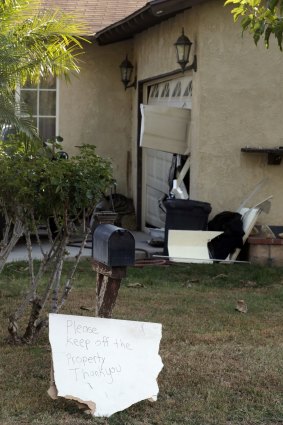 Damage to a home in Riverside, California, is shown, after law enforcement raided it on Friday in connection with the San Bernardino massacre investigation. 