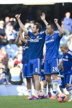 Chelsea's John Terry, right, Frank Lampard, center, and Joe Cole salute the fans.