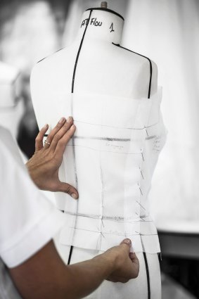 A pattern being fitted to a mannequin inside the ateliers of the House of Dior.