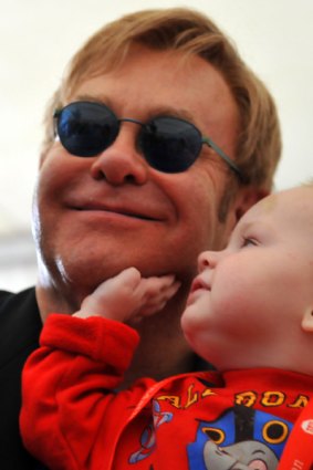 Elton John with 14-month-old Ukrainian boy Lev, who the entertainer is considering adopting.