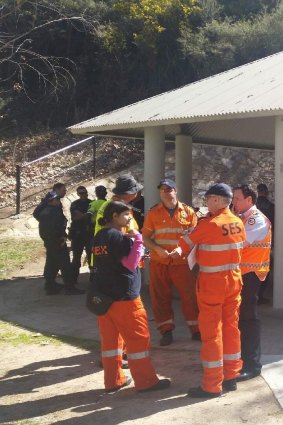 Police and the SES debrief at cotter reserve after finding missing Canberra woman Kathleen Bautista.