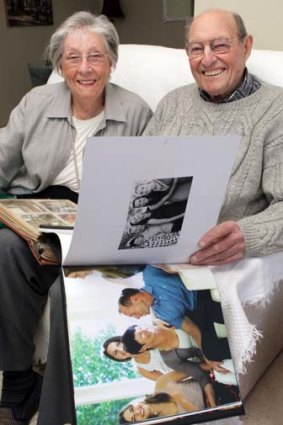 Parents Gail and Max Aitken look over family photo albums.