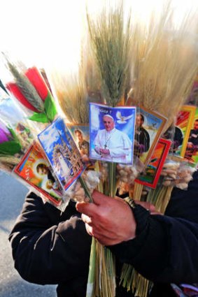 Papal pulling power: A peddler sells souvenirs bearing images of Pope Francis and Saint Cayetano.