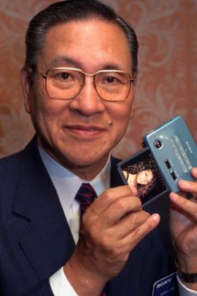 Former president and chairman of Sony, Norio Ohga, holds a Sony Mini Disc.