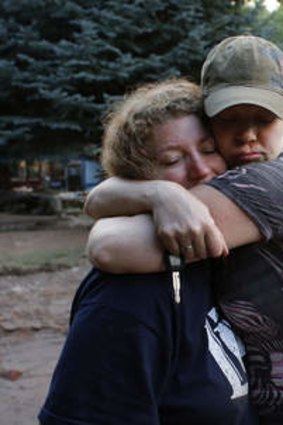 Local residents Holly Rob, right, and her neighbour and friend Pam Bowers hug after a day salvaging Rob's belongings after floods destroyed Rob's home, in Lyons, Colorado.