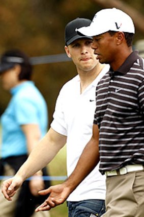 Gary Ablett gets a close look at Tiger Woods yesterday.