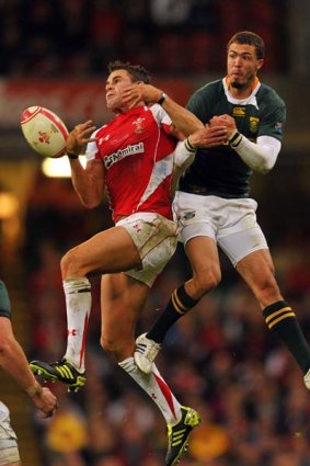 Lee Byrne (L) vies with Bjorn Basson.