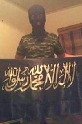 Numan Haider poses with an islamist flag.