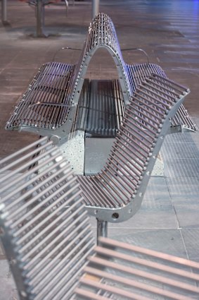 Metal rod benches allow rain to fall through.