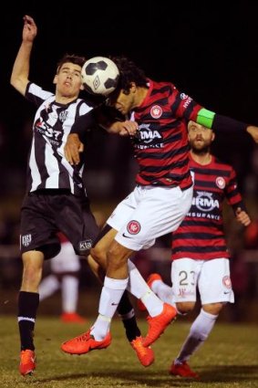 Nikolai Topor-Stanley of Western Sydney competes for the ball with Joel Allwright of Adelaide City on Tuesday night.
