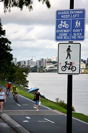 Pedestrians and cyclists share the Bicentennial Bikeway, alongside Coronation Drive in Toowong.