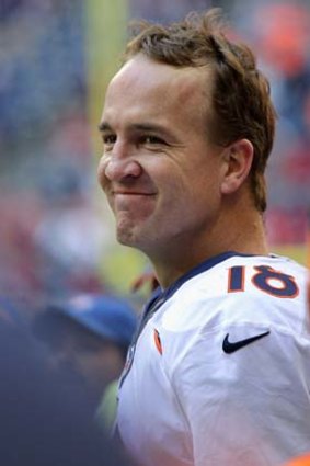 Peyton Manning acknowledges the crowd after throwing a record 51 touchdowns in a season.