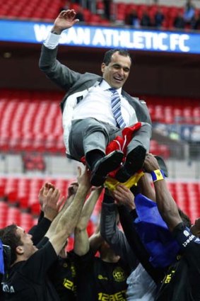 High time: Wigan manager Roberto Martinez and team celebrate winning the FA Cup.